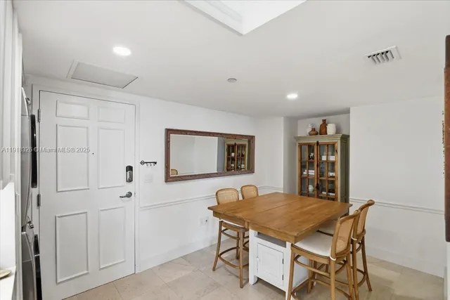 a room with a table chairs and wooden floor