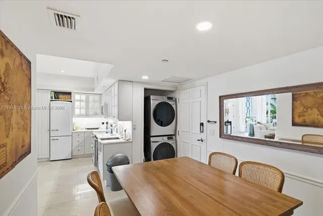 a kitchen with refrigerator and cabinets