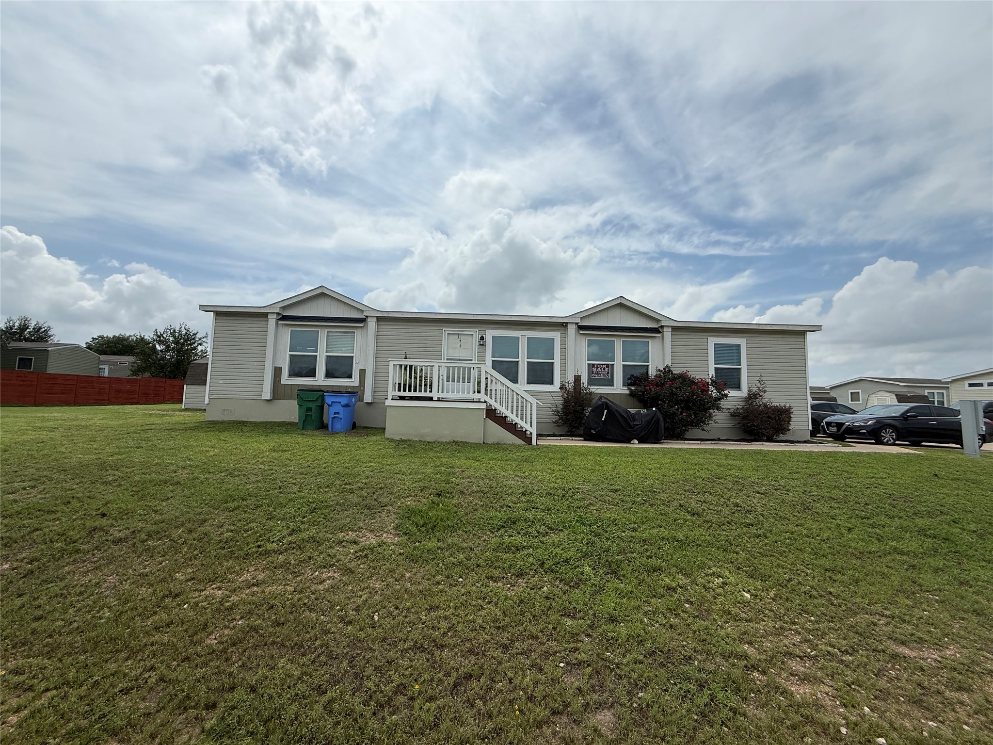 A welcoming front porch leads to this charming home with ample yard space.