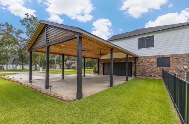 a view of a house with a backyard and a patio