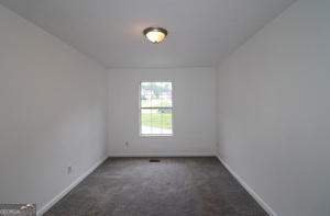 5851 Giles Road Lithonia, GA 30058 - Photo 12 of 15 an empty room with a window