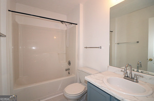 5851 Giles Road Lithonia, GA 30058 - Photo 13 of 15 a bathroom with a sink toilet and shower