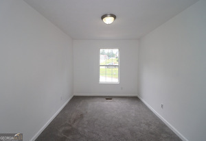 5851 Giles Road Lithonia, GA 30058 - Photo 14 of 15 an empty room with a window