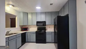 a kitchen with a refrigerator and a sink