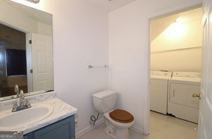 5851 Giles Road Lithonia, GA 30058 - Photo 7 of 15 a bathroom with a sink toilet and a mirror