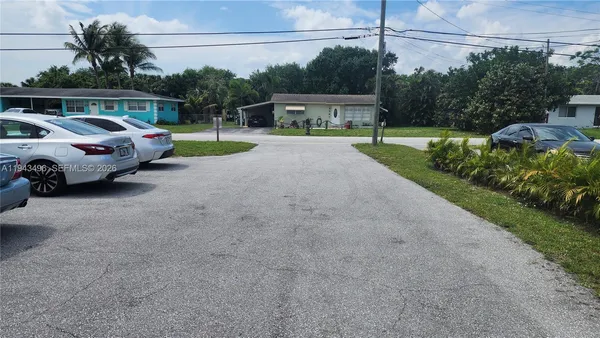 a view of a street with cars parked
