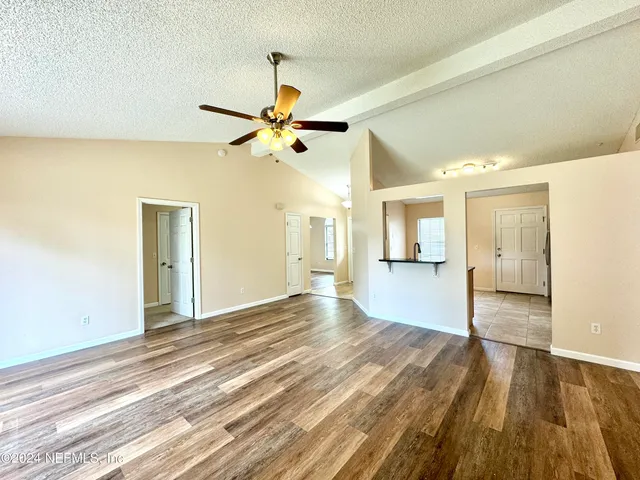 a view of an empty room and wooden floor