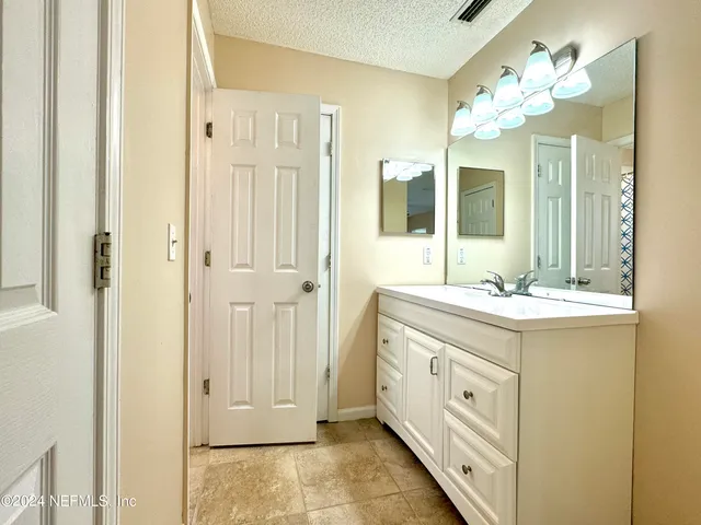 a bathroom with a double vanity sink and a mirror