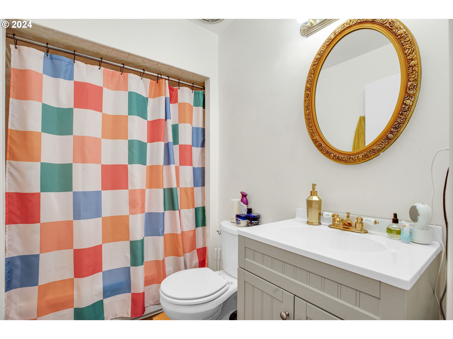 1315 North Russet Street Portland, OR 97217 - Photo 12 of 21 a bathroom with a sink a toilet and a mirror