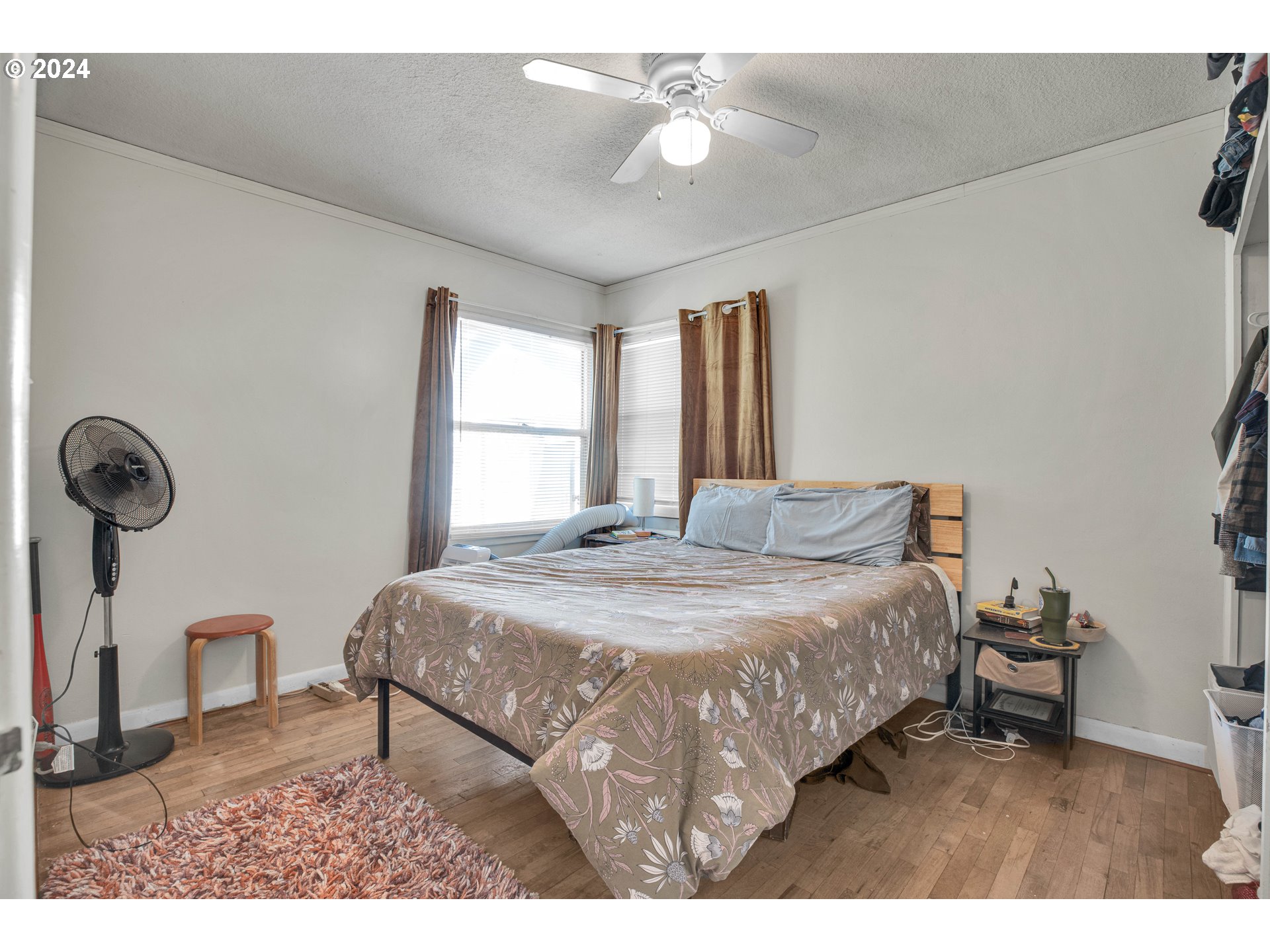 1315 North Russet Street Portland, OR 97217 - Photo 10 of 21 a bedroom with a bed a chandelier and a window