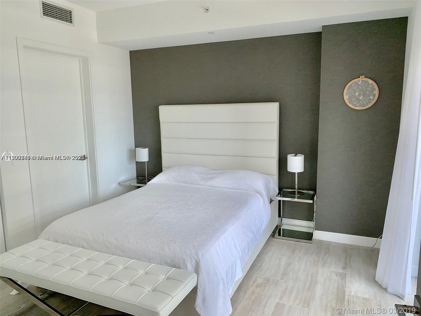 55 Southwest 9th Street, Unit 2003 Miami, FL 33130 - Photo 5 of 8 a bedroom with a bed and a table