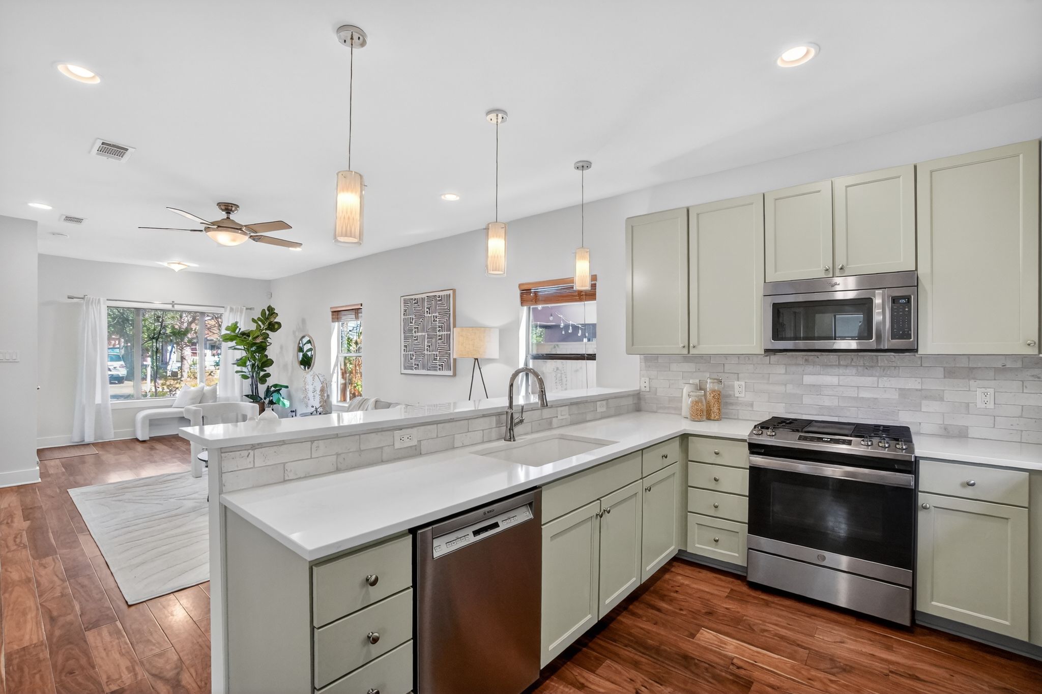 1203 East 2nd Street, Unit A Austin, TX 78702 - Photo 12 of 39 a kitchen with stainless steel appliances granite countertop a sink a stove and oven