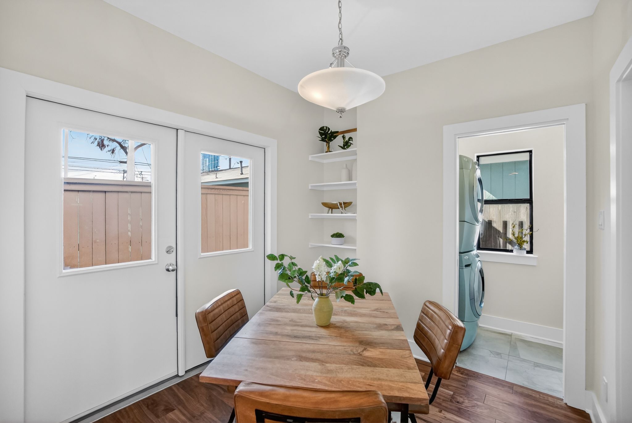 1203 East 2nd Street, Unit A Austin, TX 78702 - Photo 16 of 39 a view of a dining room with furniture wooden floor and a chandelier