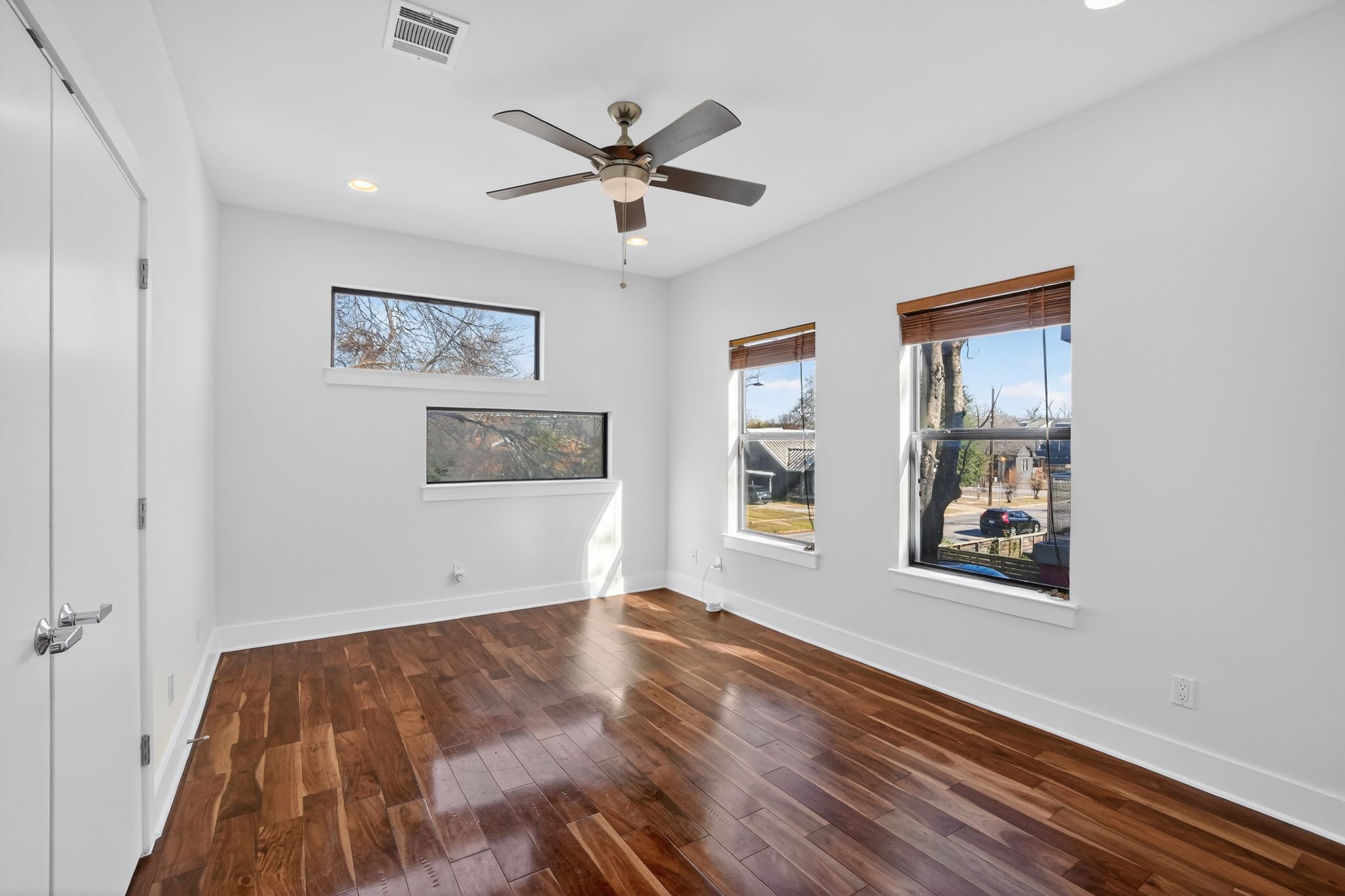 1203 East 2nd Street, Unit A Austin, TX 78702 - Photo 29 of 39 a view of an empty room with wooden floor and a window