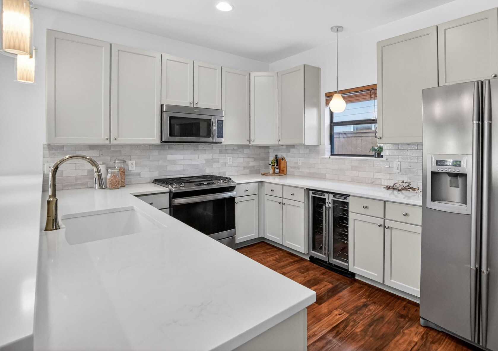 1203 East 2nd Street, Unit A Austin, TX 78702 - Photo 2 of 39 a kitchen with stainless steel appliances granite countertop a sink stove and refrigerator