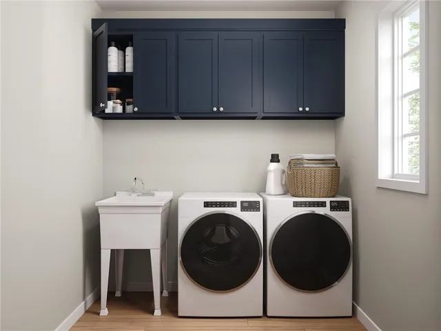 a utility room with sink dryer and washer