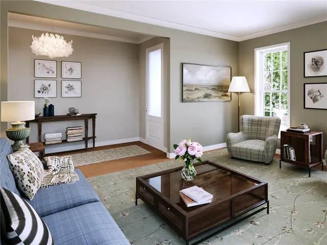 a living room with furniture potted plant and a window