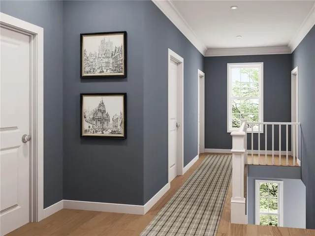 a view of a hallway with wooden floor and a window