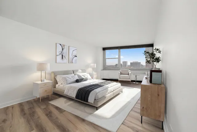 a bedroom with a bed couch and a window