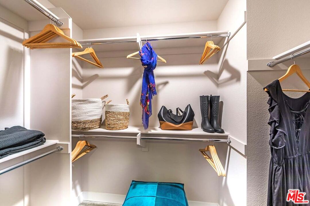 7290 Edinger Avenue, Unit 3103 Huntington Beach, CA 92647 - Photo 6 of 24 a view of walk in closet with clothes and shoes
