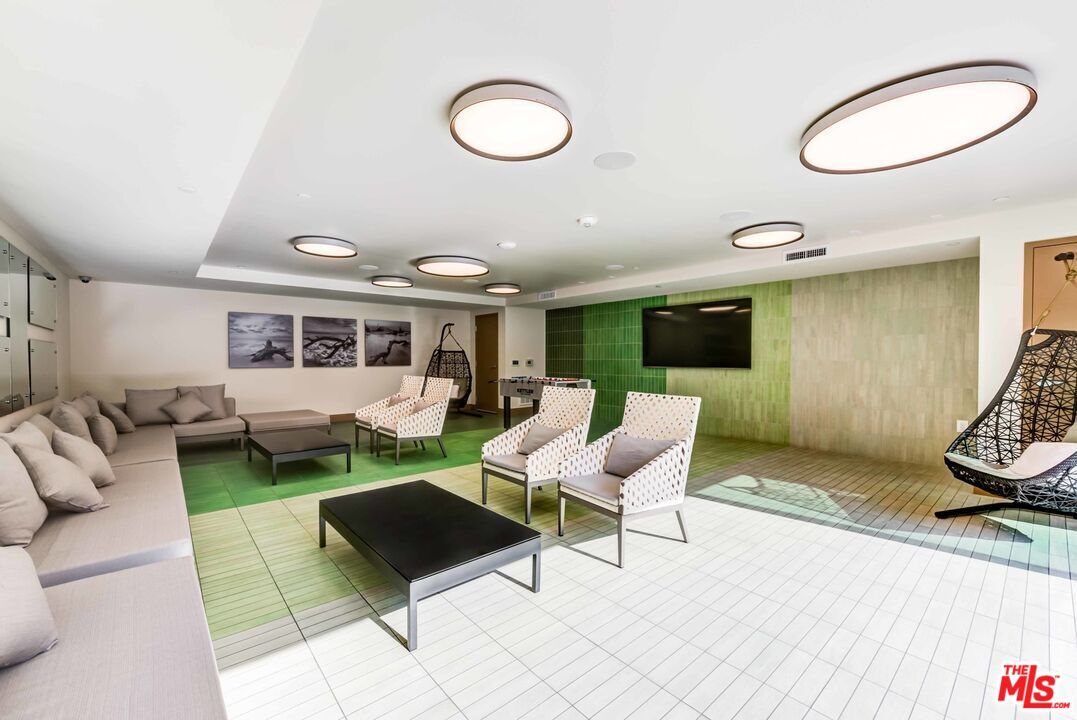 7290 Edinger Avenue, Unit 3103 Huntington Beach, CA 92647 - Photo 9 of 24 a living room with furniture a rug and a large window