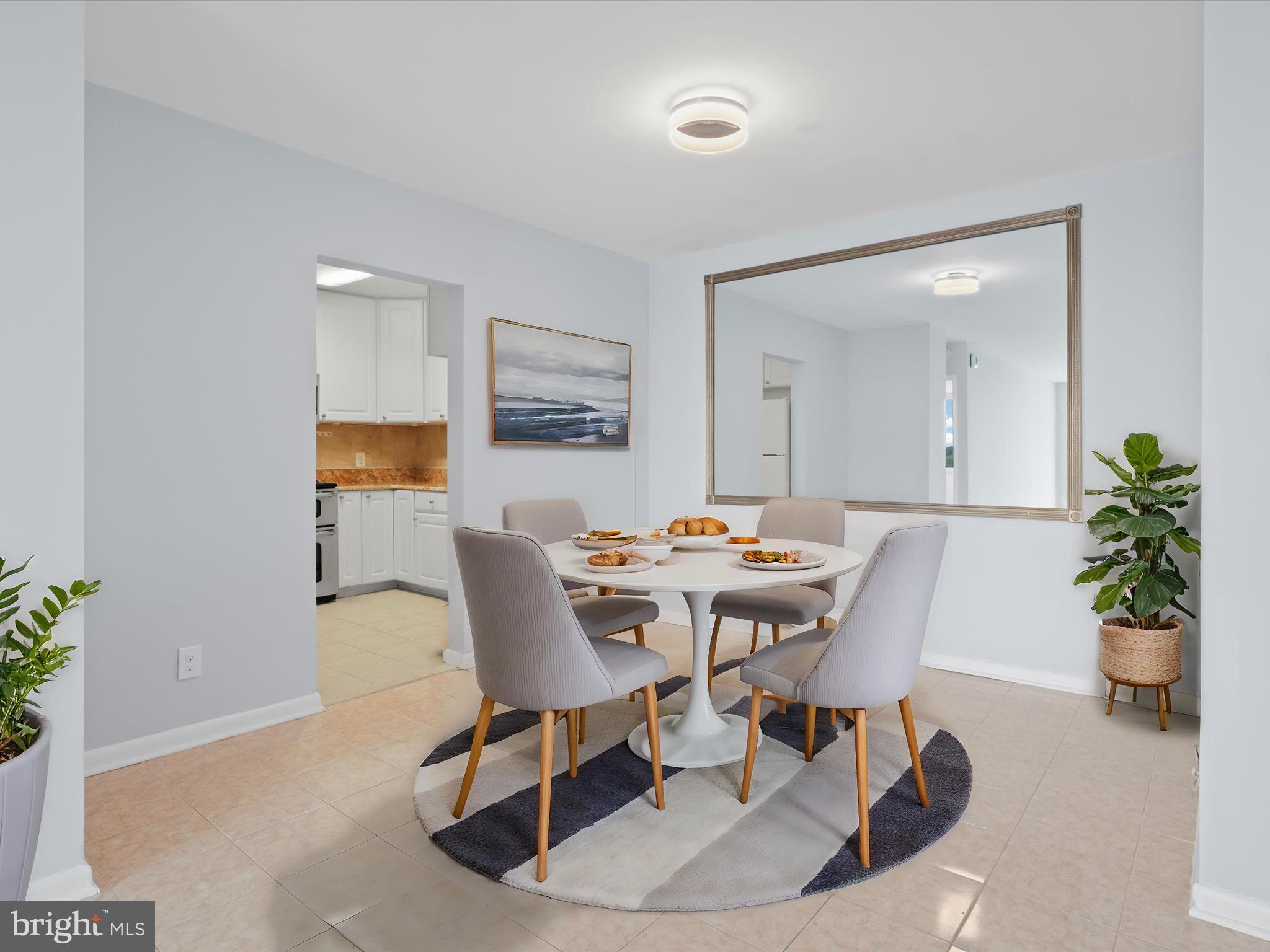 5101 River Road, Unit 1807 Bethesda, MD 20816 - Photo 12 of 32 a view of a dining room with a table and chairs