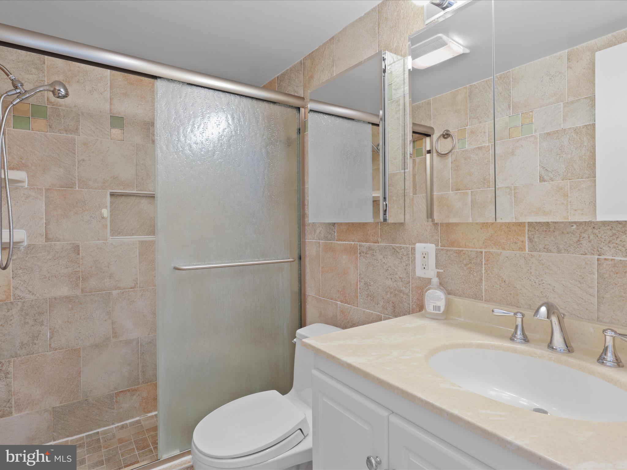 5101 River Road, Unit 1807 Bethesda, MD 20816 - Photo 20 of 32 a bathroom with a sink toilet and shower