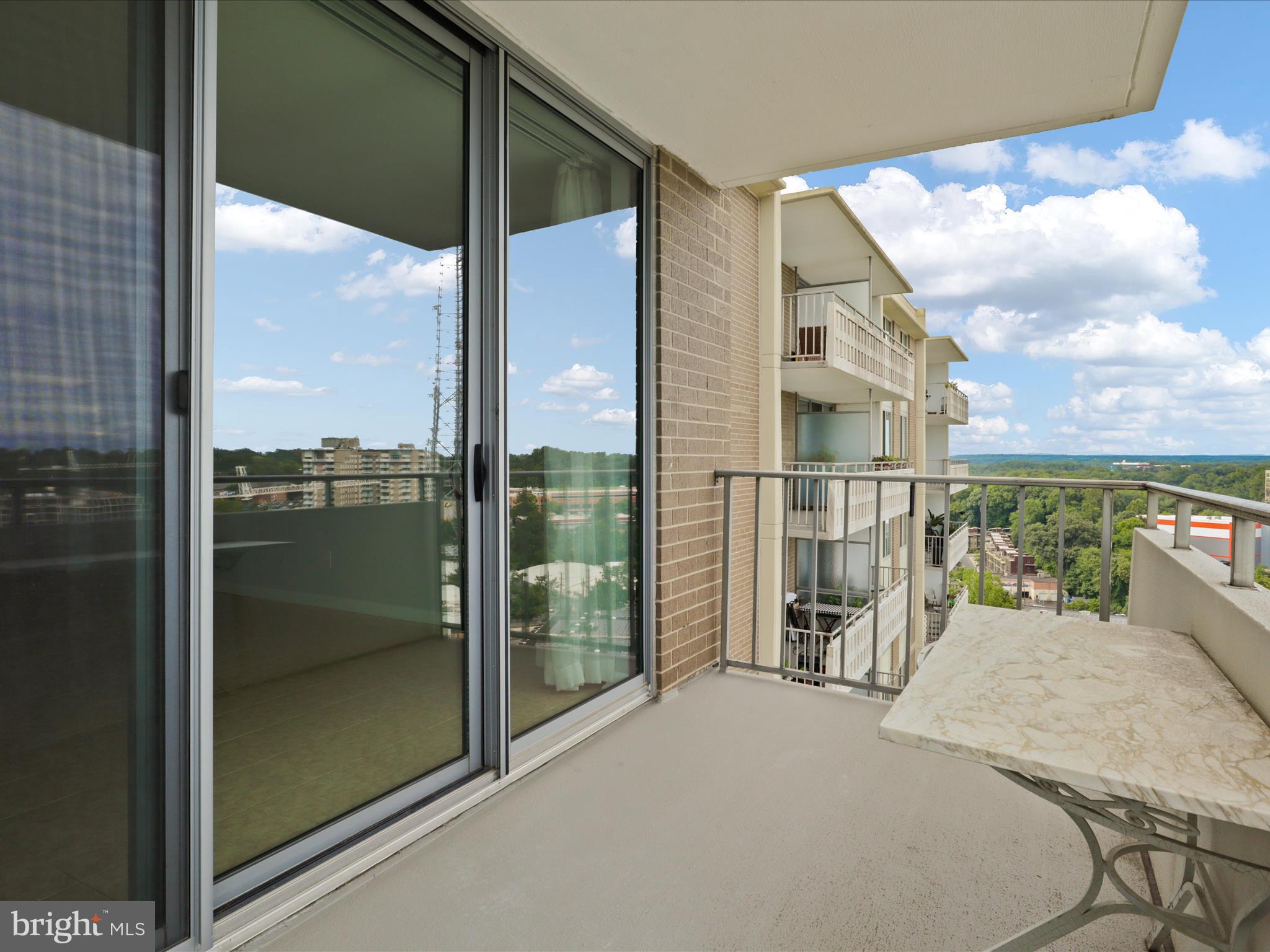 5101 River Road, Unit 1807 Bethesda, MD 20816 - Photo 22 of 32 a view of a balcony with floor to ceiling windows