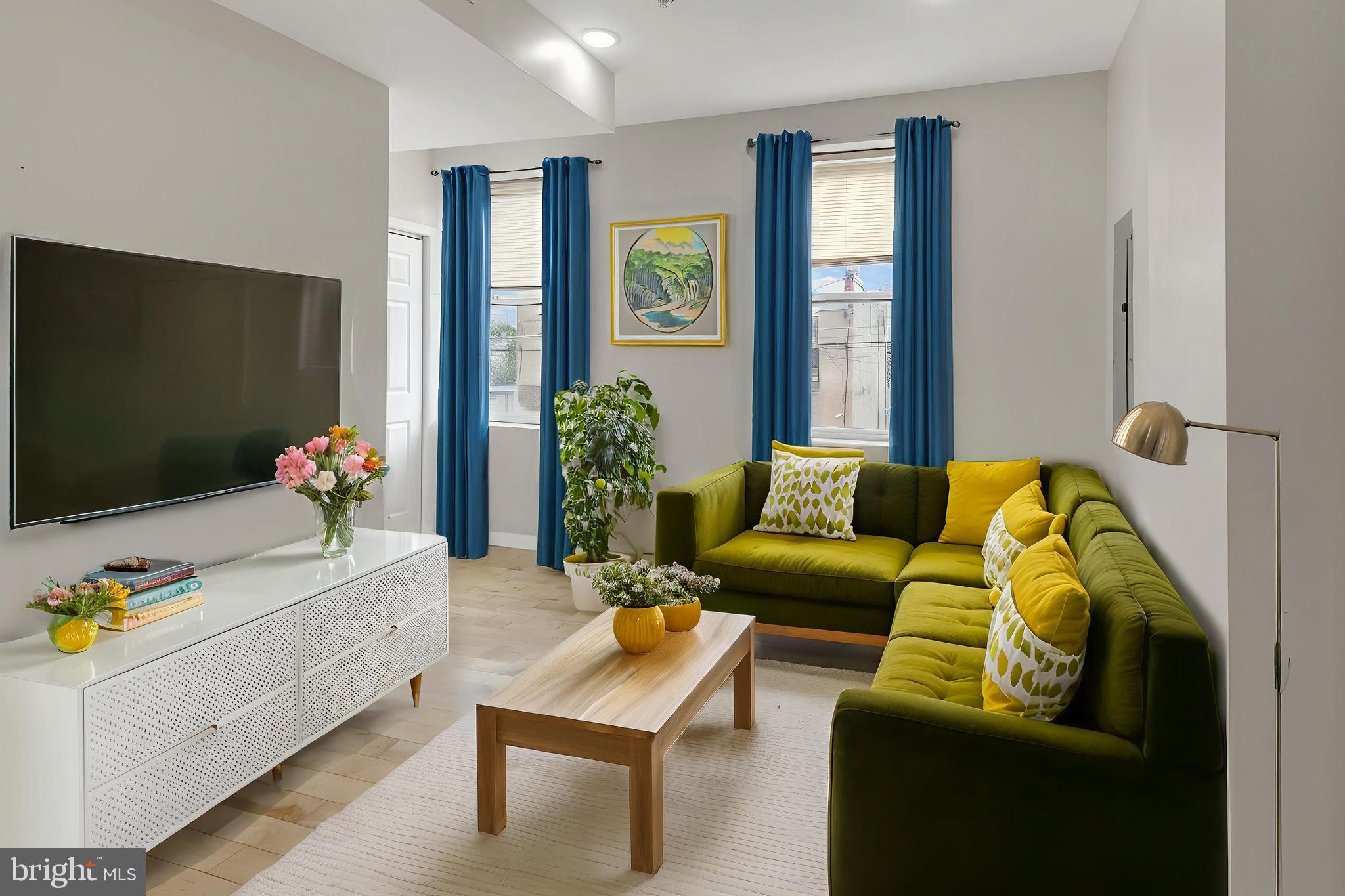 2604 Frankford Avenue, Unit 3 Philadelphia, PA 19125 - Photo 1 of 13 a living room with furniture and a flat screen tv