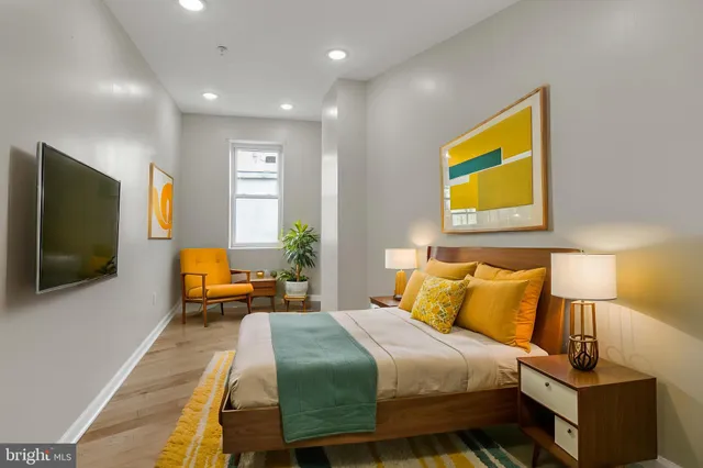 a bedroom with a bed and flat screen tv