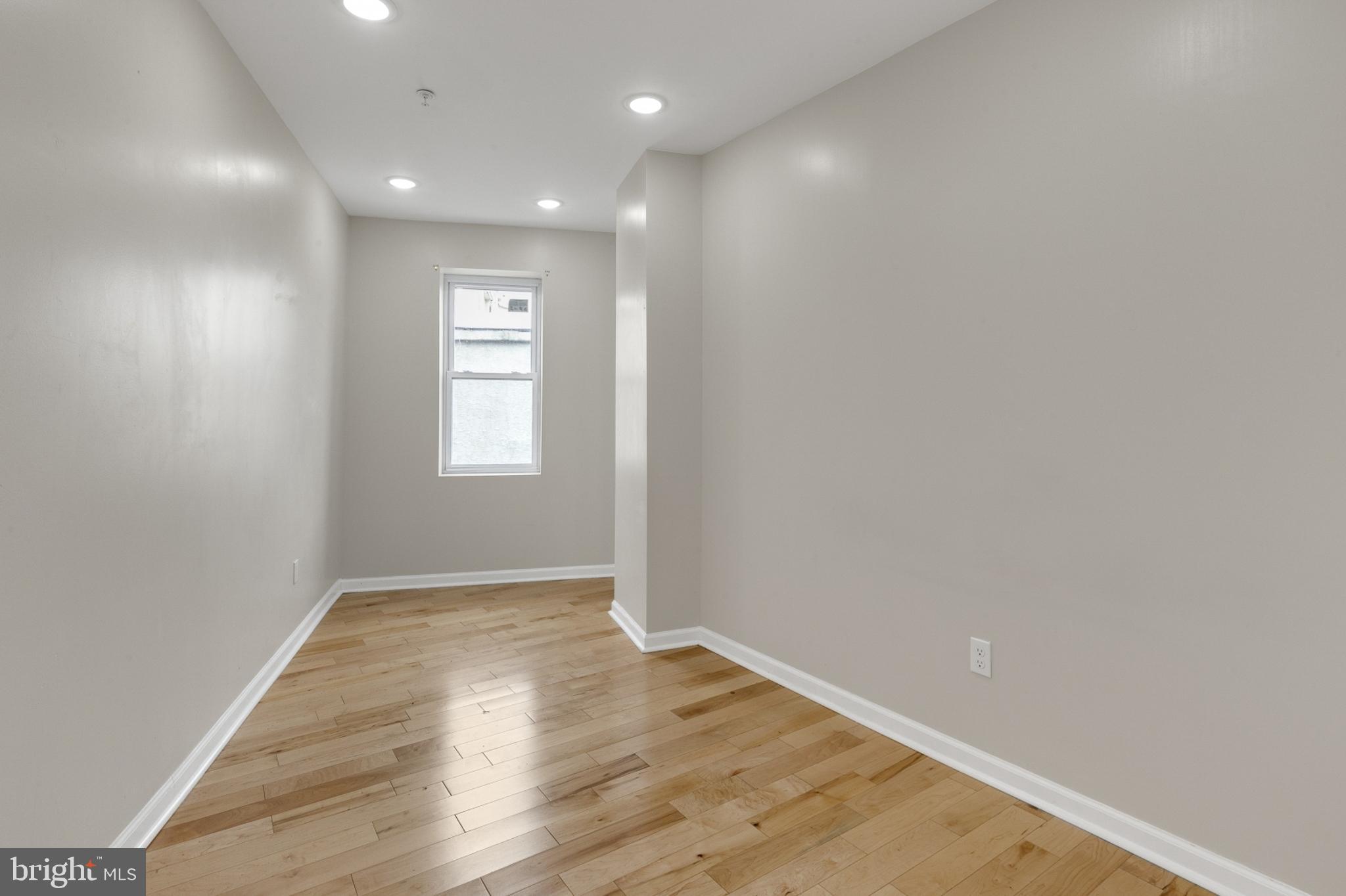 2604 Frankford Avenue, Unit 3 Philadelphia, PA 19125 - Photo 10 of 13 an empty room with wooden floor and windows