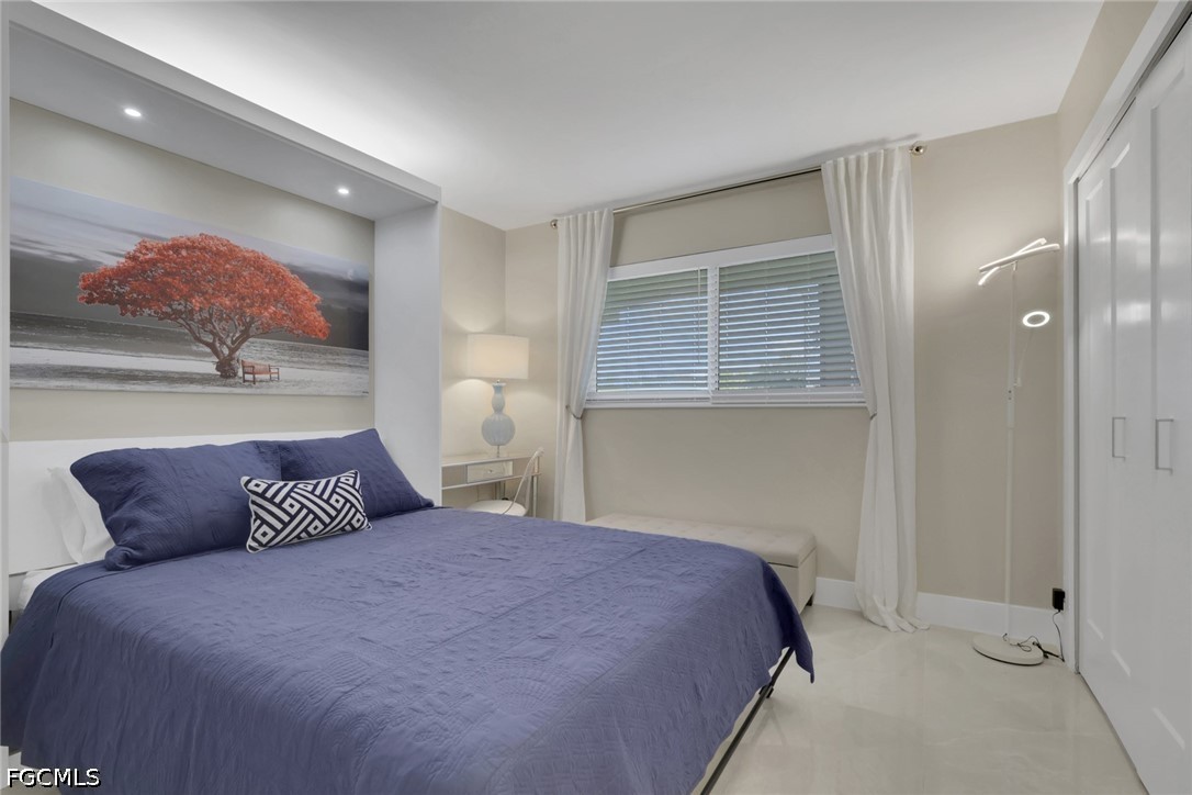9 High Point Circle North, Unit 101 Naples, FL 34103 - Photo 28 of 49 a bedroom with a bed and window