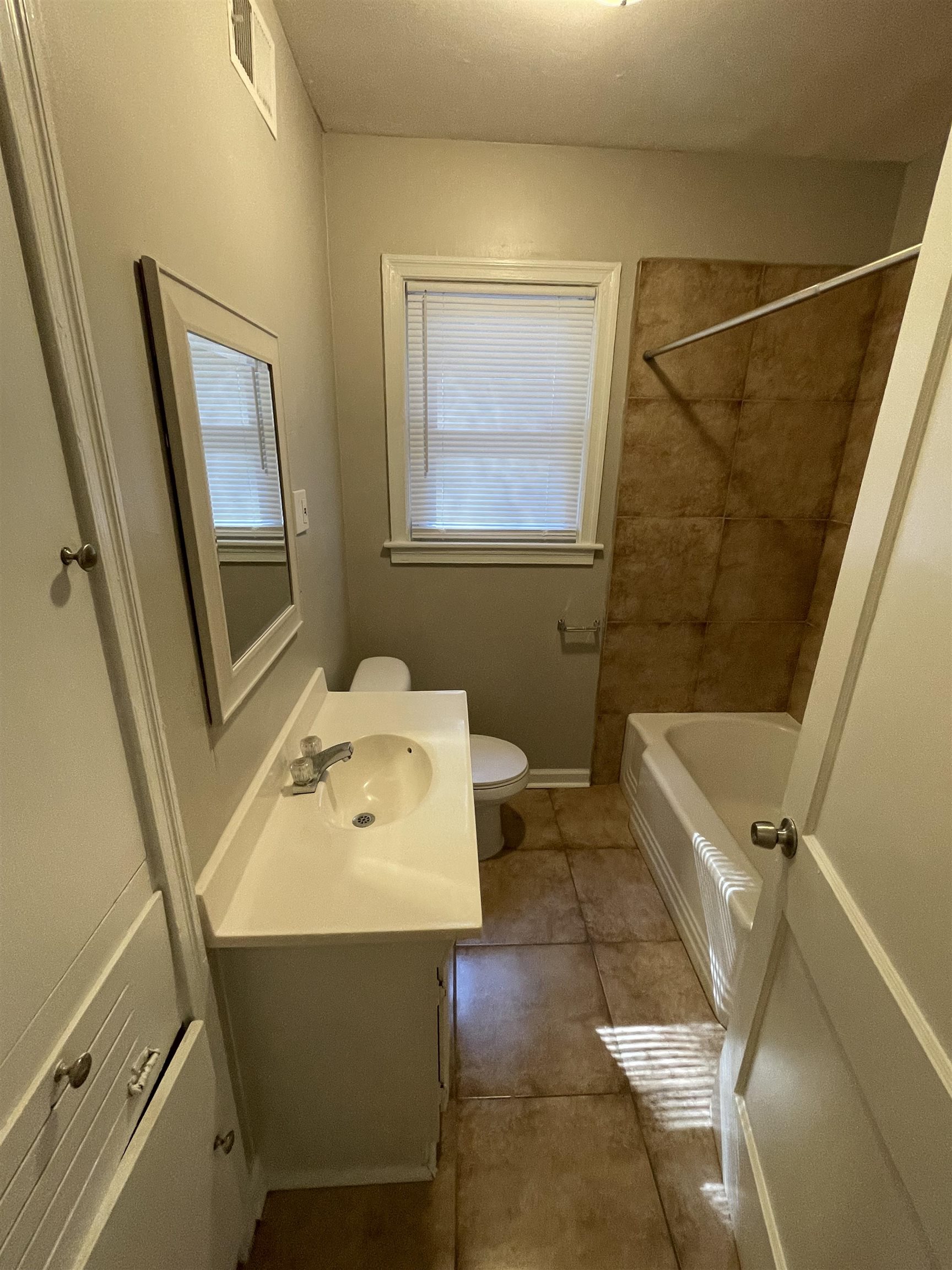 1451 Titus Road Memphis, TN 38111 - Photo 8 of 11 a bathroom with a sink mirror vanity and toilet