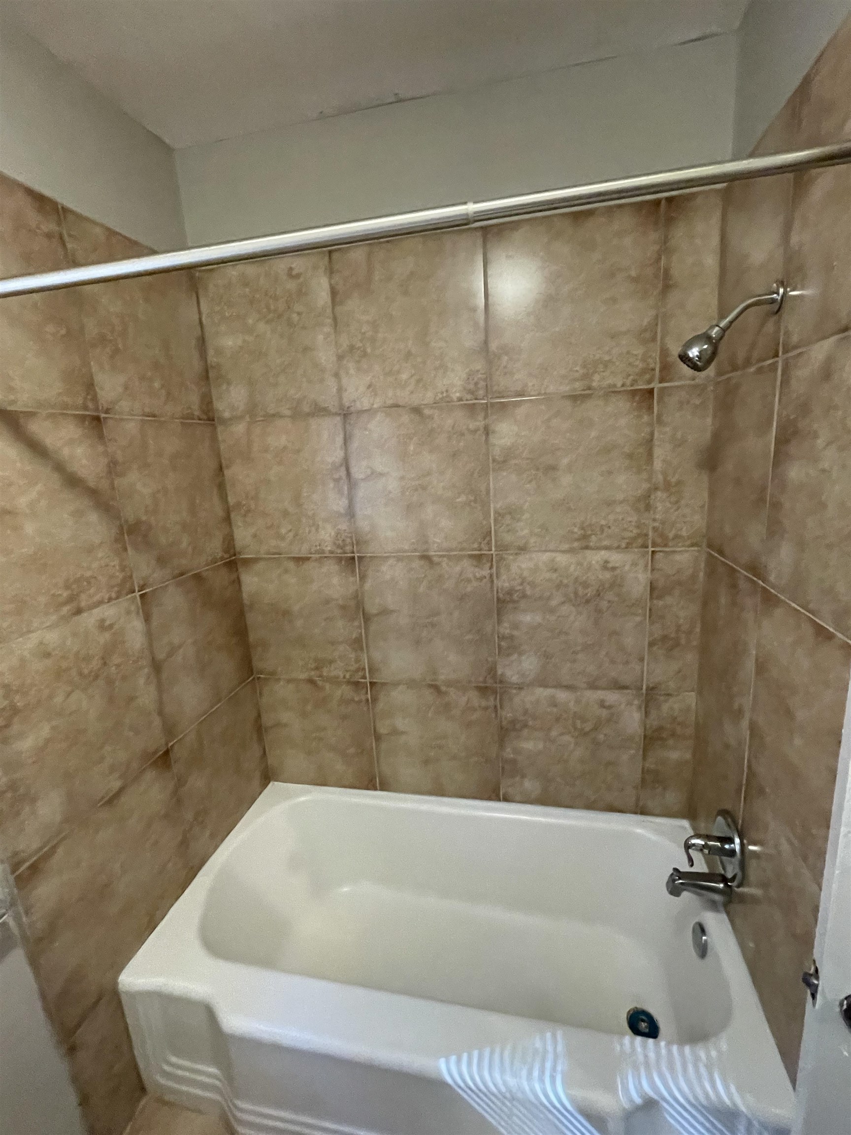1451 Titus Road Memphis, TN 38111 - Photo 9 of 11 a bathroom with a bathtub and a shower