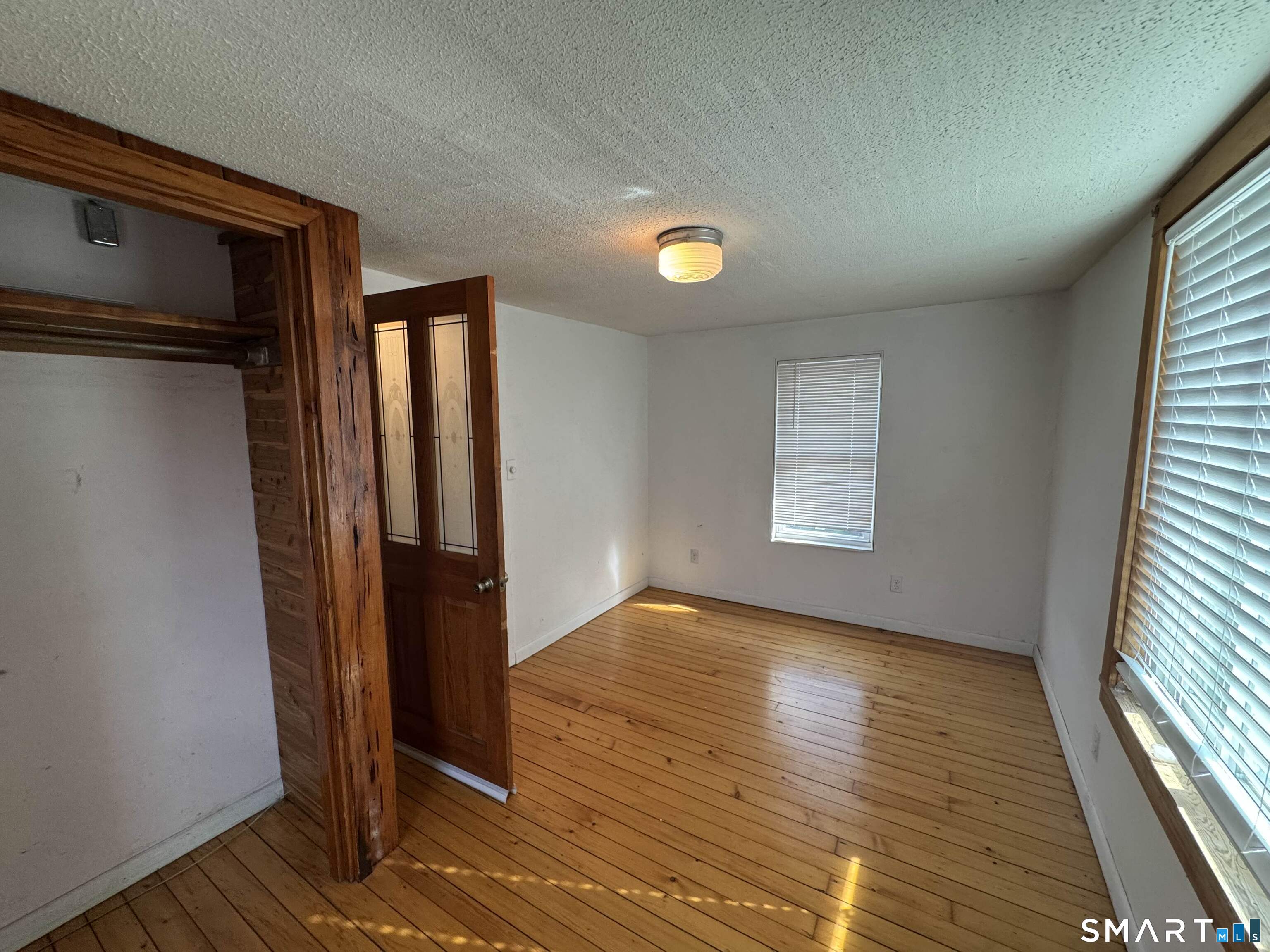 527 Worthington Ridge Berlin, CT 06037 - Photo 18 of 34 wooden floor in an empty room with a window