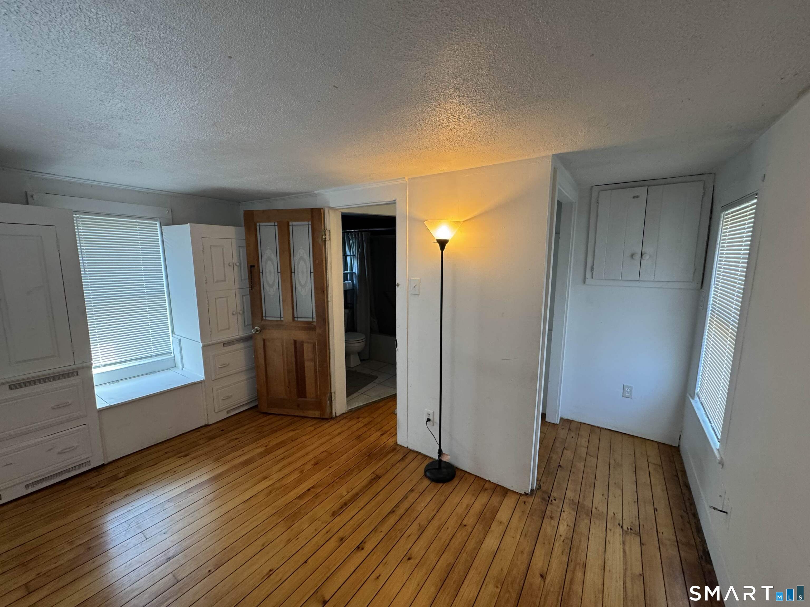 527 Worthington Ridge Berlin, CT 06037 - Photo 20 of 34 an empty room with wooden floor and windows