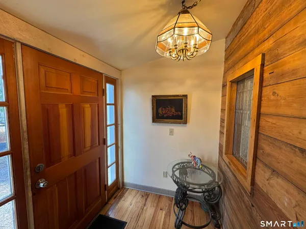 a room with wooden door and furniture