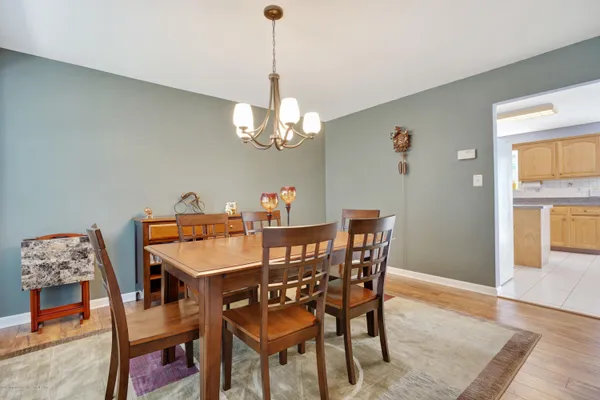 a kitchen with stainless steel appliances granite countertop a refrigerator a stove a sink dishwasher and a dining table with the view of kitchen