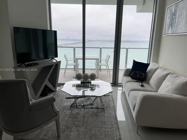 a living room with furniture fireplace and a flat screen tv