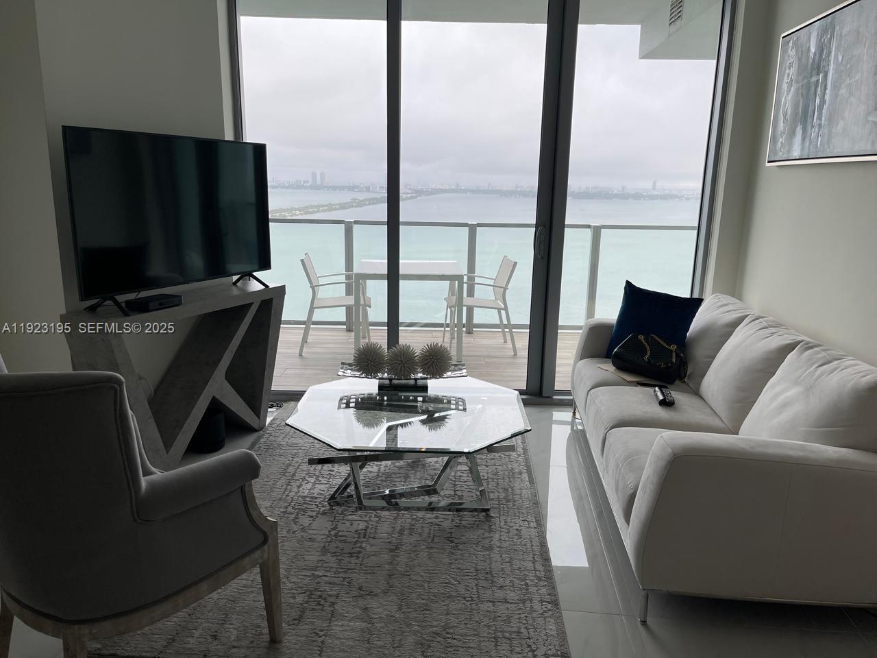2900 Northeast 7th Avenue, Unit 3203 Miami, FL 33137 - Photo 2 of 8 a living room with furniture fireplace and a flat screen tv
