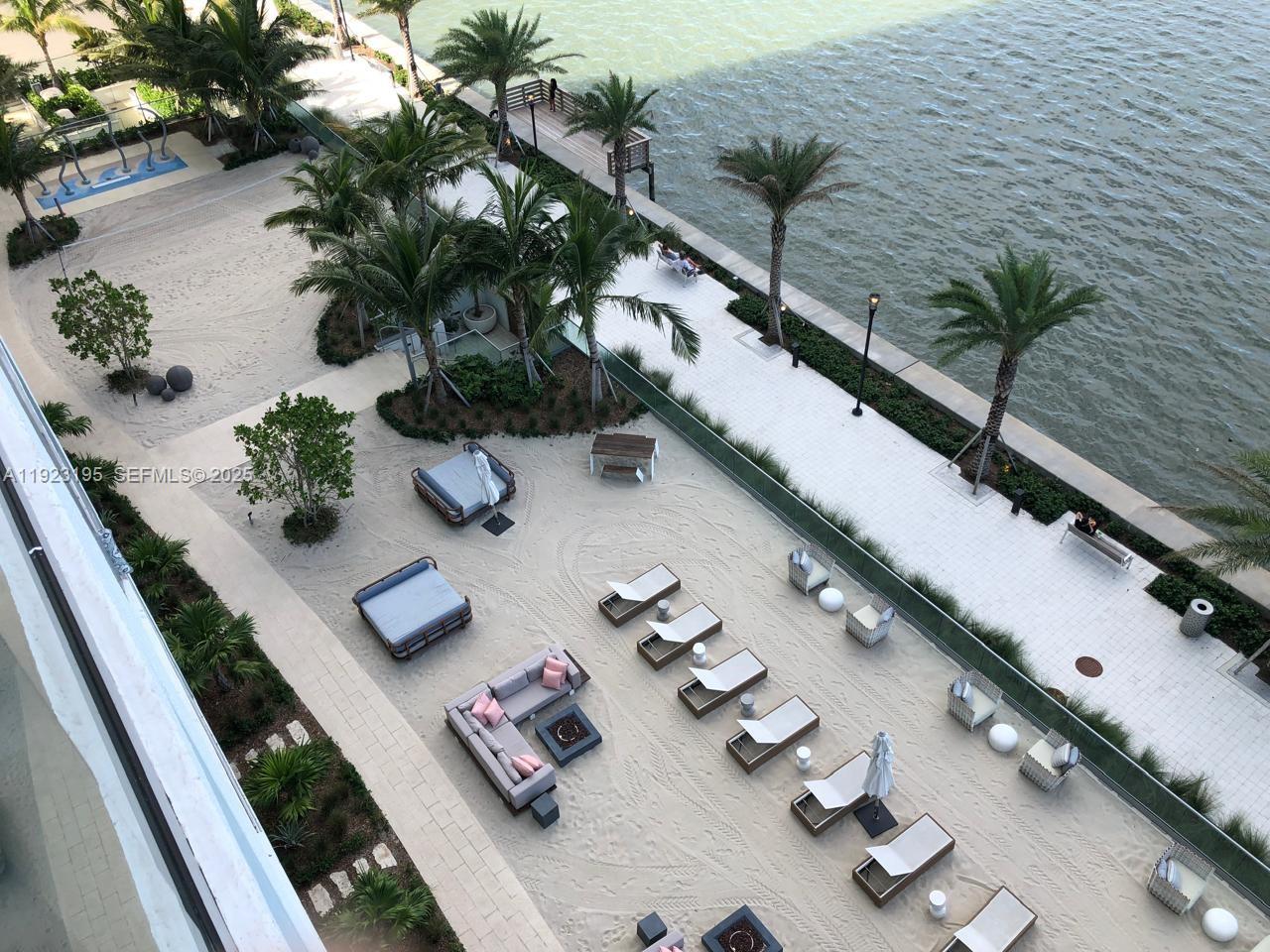 2900 Northeast 7th Avenue, Unit 3203 Miami, FL 33137 - Photo 5 of 8 a white table sitting in a flower room with wooden floor