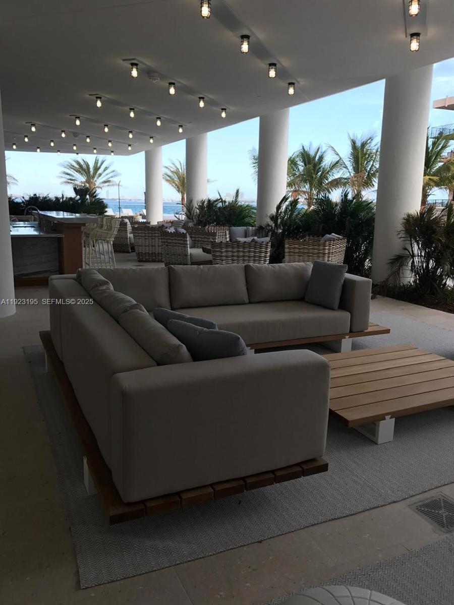 2900 Northeast 7th Avenue, Unit 3203 Miami, FL 33137 - Photo 7 of 8 a living room with furniture and a view of kitchen