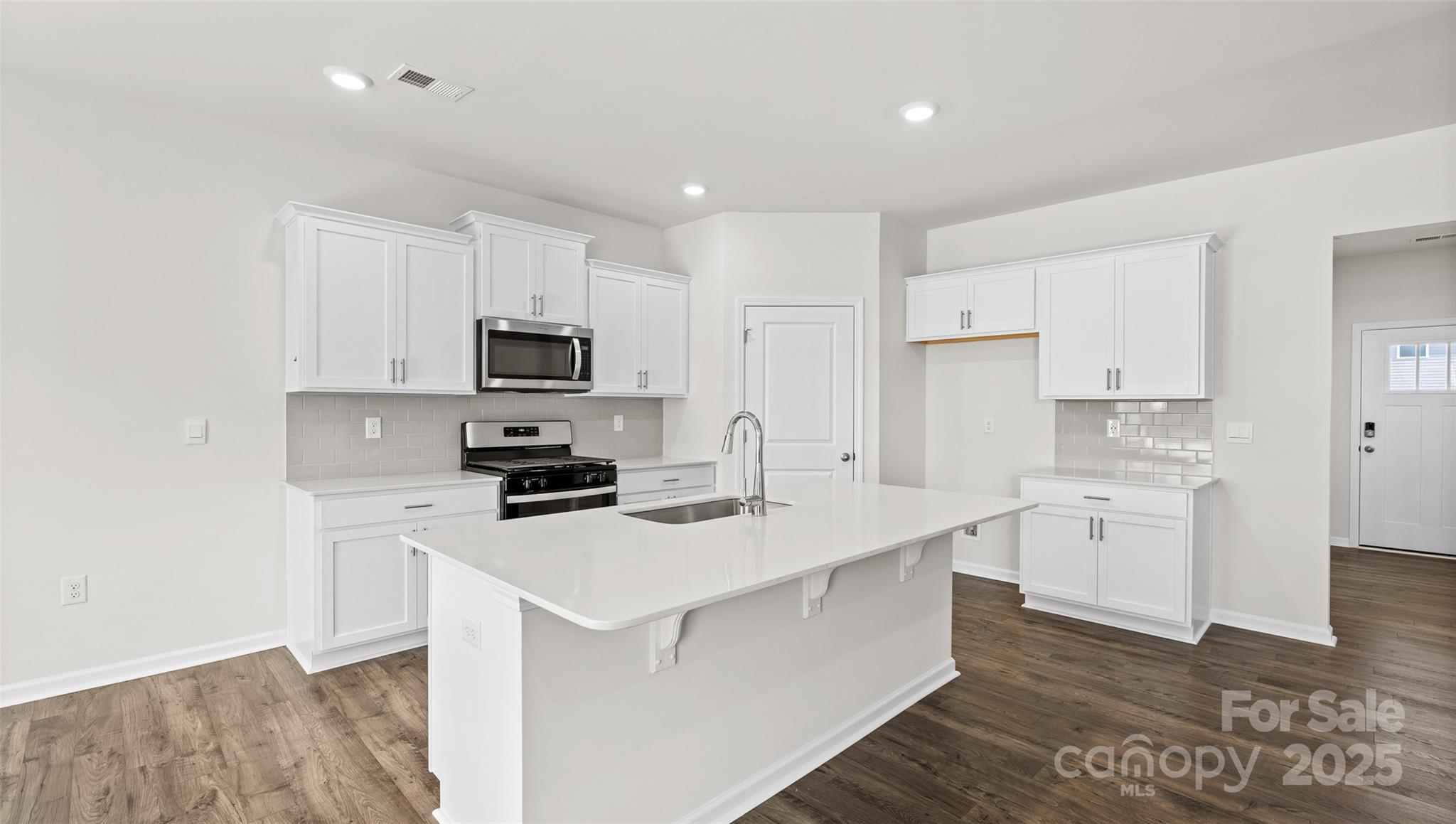 44 Bovine Br Road Fletcher, NC 28732 - Photo 4 of 26 a kitchen with white cabinets appliances and sink