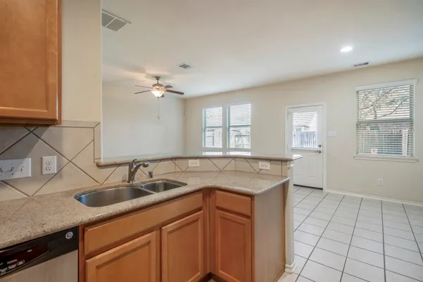 a kitchen with a sink cabinets and window