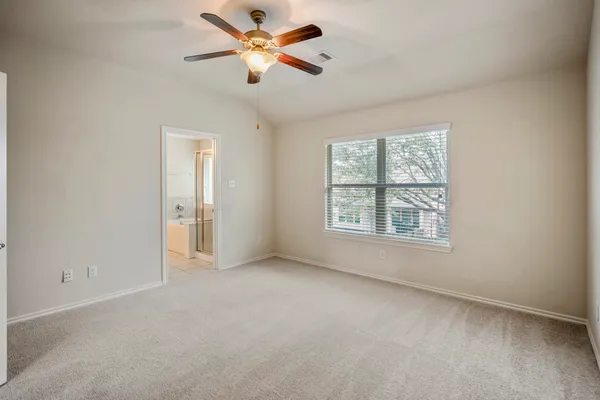 an empty room with a empty space and a ceiling fan