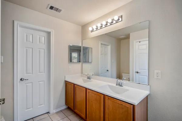 a bathroom with a tub sink and mirror