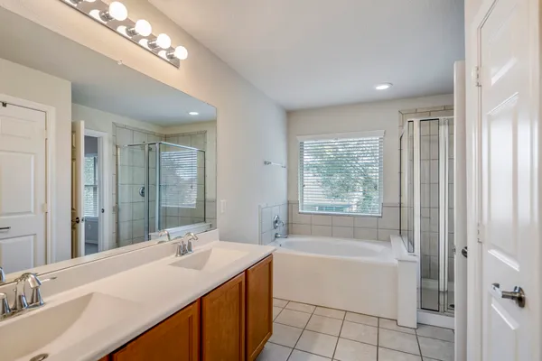 a white bath tub sitting next to a shower