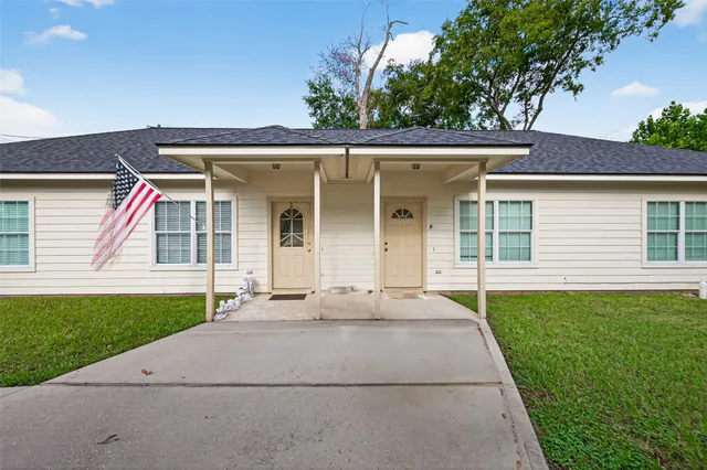 a bathroom with a granite countertop toilet and a sink