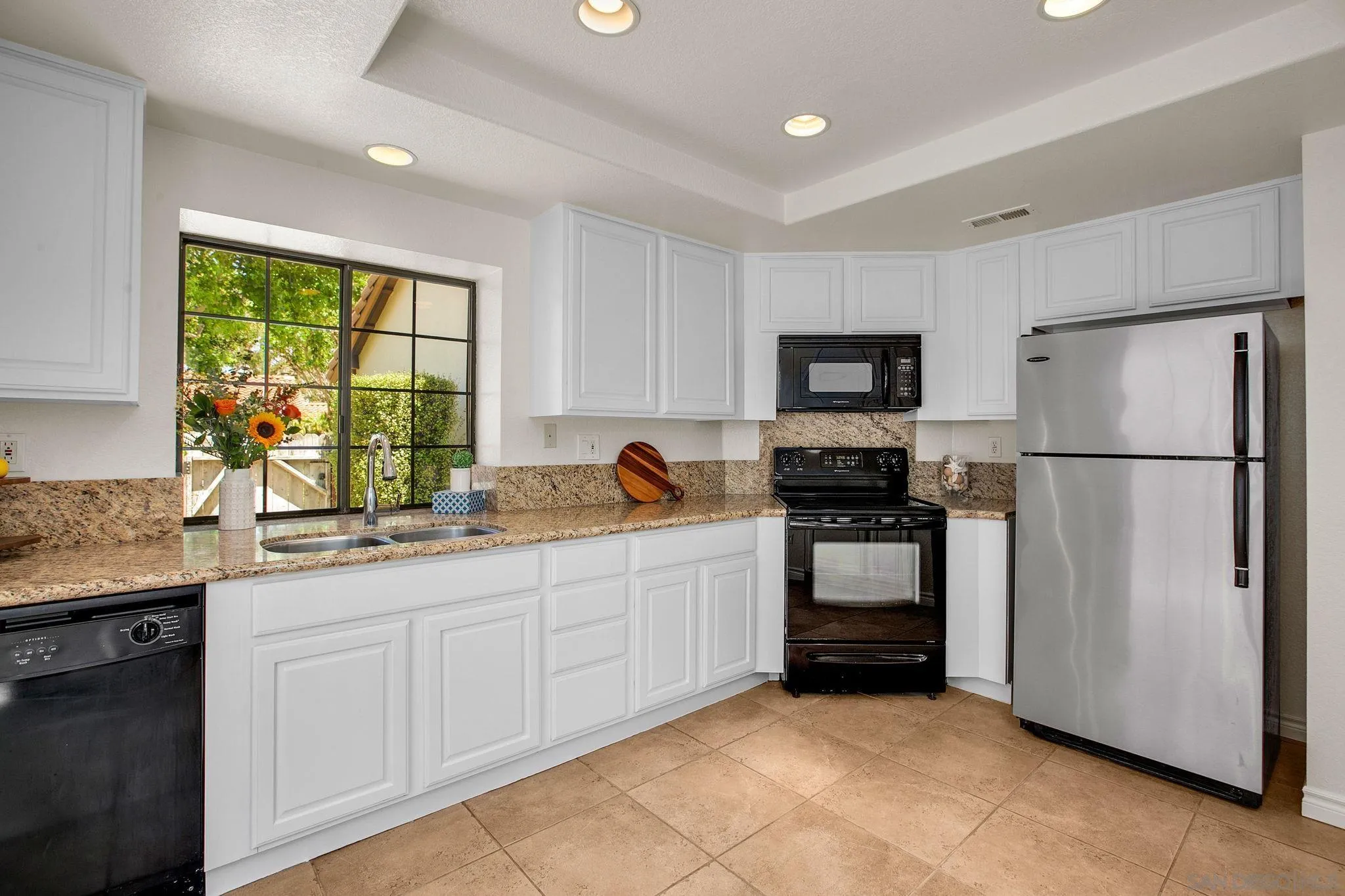 2041 Coolngreen Lane Encinitas, CA 92024 - Photo 16 of 36 a kitchen with granite countertop a refrigerator and a sink