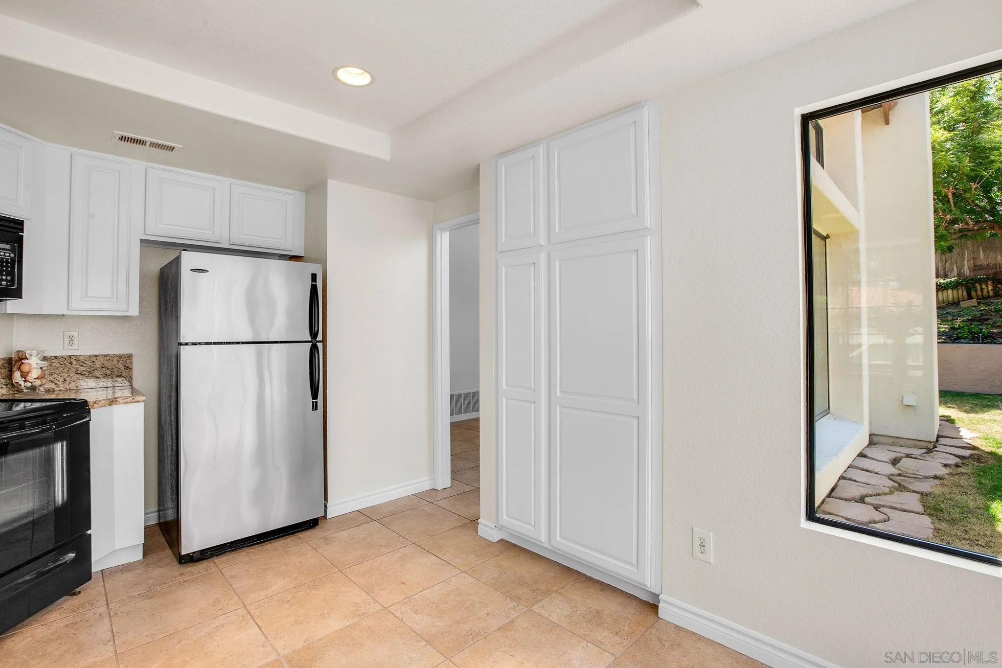 2041 Coolngreen Lane Encinitas, CA 92024 - Photo 17 of 36 a view of a refrigerator in kitchen and furniture